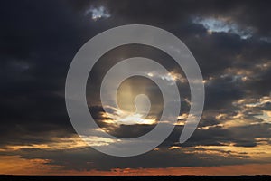 The rays of sunset break through the clouds.