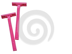 Razor in a female hand on a pink background.Removal of unwanted hair. top view. Concept of using razor.