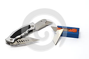 Razor type cutting tool with sharp blade and replacement blades on white background