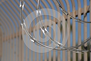 Razor wire closeup with bar fence Secrity Location