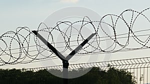 Razor Wire Fence Around the Solar Power Plant During Sunset