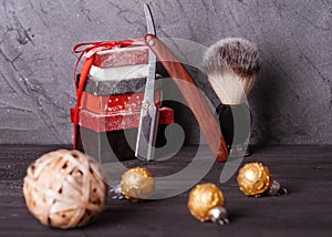 Razors, brush, christmas gift and decoration on wood background