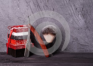 Razors, brush, christmas gift on wood background