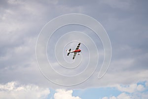 RC propeller aircraft flying on a cloudy sky