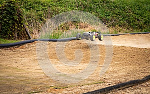 RC truggy going fast on an offroad outdoor track