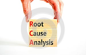 RCA root cause analysis symbol. Concept words RCA root cause analysis on wooden block. Businessman hand. Beautiful white table