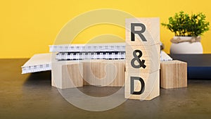 rd - text on wood cubes stack, yellow background