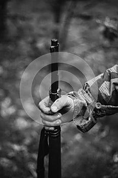 Re-enactor Dressed As World War II German Wehrmacht Soldier Holds Rifle. Photo In Black And White Colors