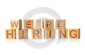 We`re Hiring written on wooden cube blocks on white - human resources or job vacancy concept