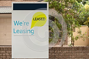 We`re leasing and leased sign on a white display