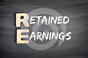 RE - Retained Earnings acronym, business concept on blackboard