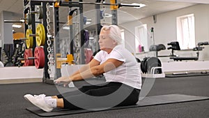 Reabelitation after injury. elderly woman plays sports in the gym. Healthy lifestyle, retired concept, senior, indoor