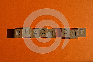Reach Out, phrase in wood letters, buzzword meaning to communicate