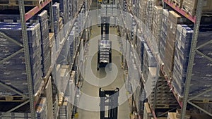 Reach truck works between the warehouse shelves