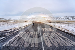 Reach your goals sign on the road with a woman who try to reach her destination