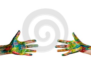 Reaching a hand. Close-up of human hands painted in bright colors trying to reach each other isolated on white. Clipping