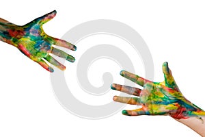 Reaching a hand. Close-up of human hands painted in bright colors trying to reach each other isolated on white. Clipping