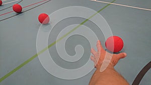 Reaching out a hand for a red dodgeball