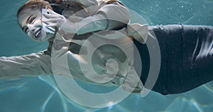 Reaching to help clients. Cinematic shot of beautiful young business woman talking on phone under water slow motion.