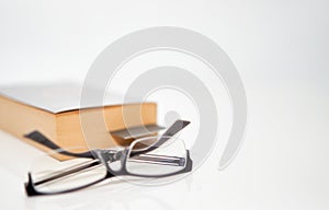 Read glasses selective focus on blur Bookmark in old book on white background