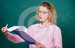 Read impressing resume. School project. Literature teacher read composition. Woman smart lady hold tablet documents photo