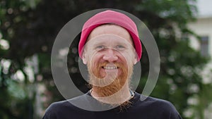 Readhead hipster in hat laughs suddenly
