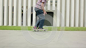 Readhead Hipster in Hat on a Skateboard