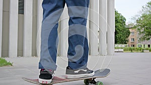 Readhead Hipster in Hat on a Skateboard