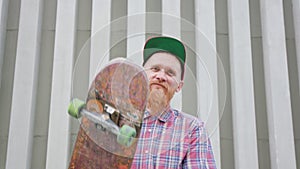 Readhead Hipster in Hat With a Skateboard