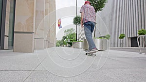 Readhead hipster in hat on a skateboard