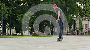 Readhead hipster in hat with a skateboard