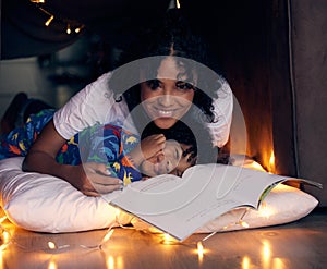 Reading, bedroom and portrait of kid with mom in home, smile and child together with mother for love. Young boy, pyjamas