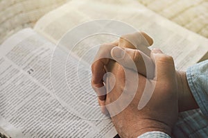 Reading the bible. Prayer. Hands folded in prayer concept. The concept of faith