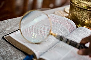 Reading the bible with reading glasses and magnify glass John 3:16