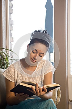 Reading a book on couch