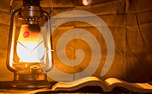 Reading book with hurricane Lamp in old days