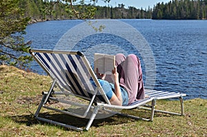 Reading book by the lake