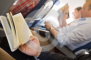 Reading books in airplane.