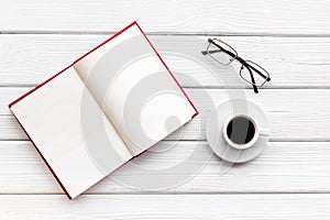 Reading books in library with glasses and coffee on white wooden background top view space for text