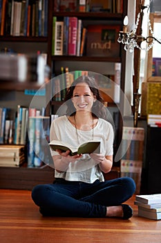 Reading, books and portrait of woman on floor in bookstore, library or shop for research, learning and relax. Literature