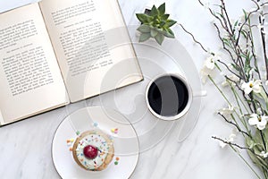 Reading with a cupcake and coffee