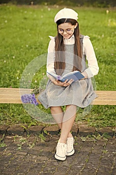 Reading development. Little child read book on park bench. Child development. Learning and mastering skills. School and