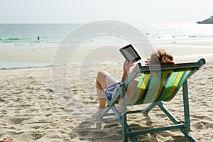 Reading e-books on a beach