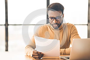 African american manager checking reports in modern office photo