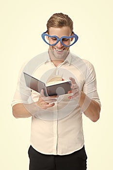 Reading is fun. Happy man read book isolated on white. Funny guy enjoy reading in fancy glasses. Bibliophile. Reading