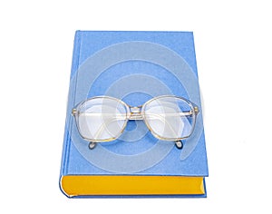 Reading glasses and book ion white background