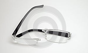 Reading glasses. elegant plastic transparent frame broken in half along the bridge between the lenses