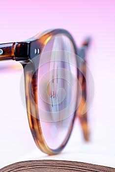 Reading glasses on opened book