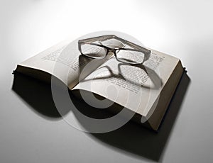 Reading glasses and open book