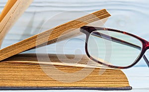 Reading glasses on an open book. Idea for reading books